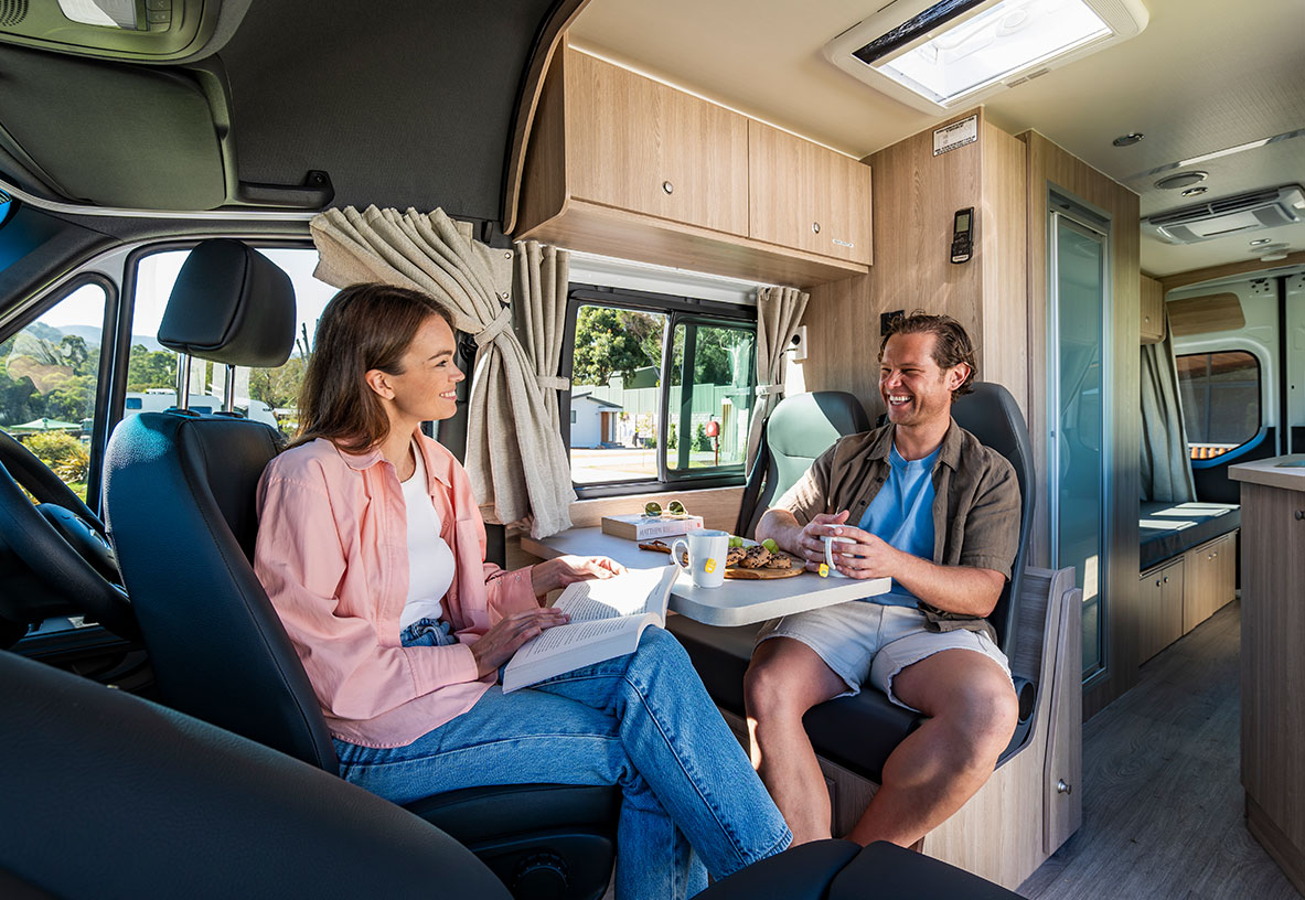 Couple Sitting at Interior Dining Space of Winnebago Motorhome