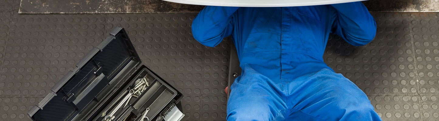 auto technician working on a vehicle with tools